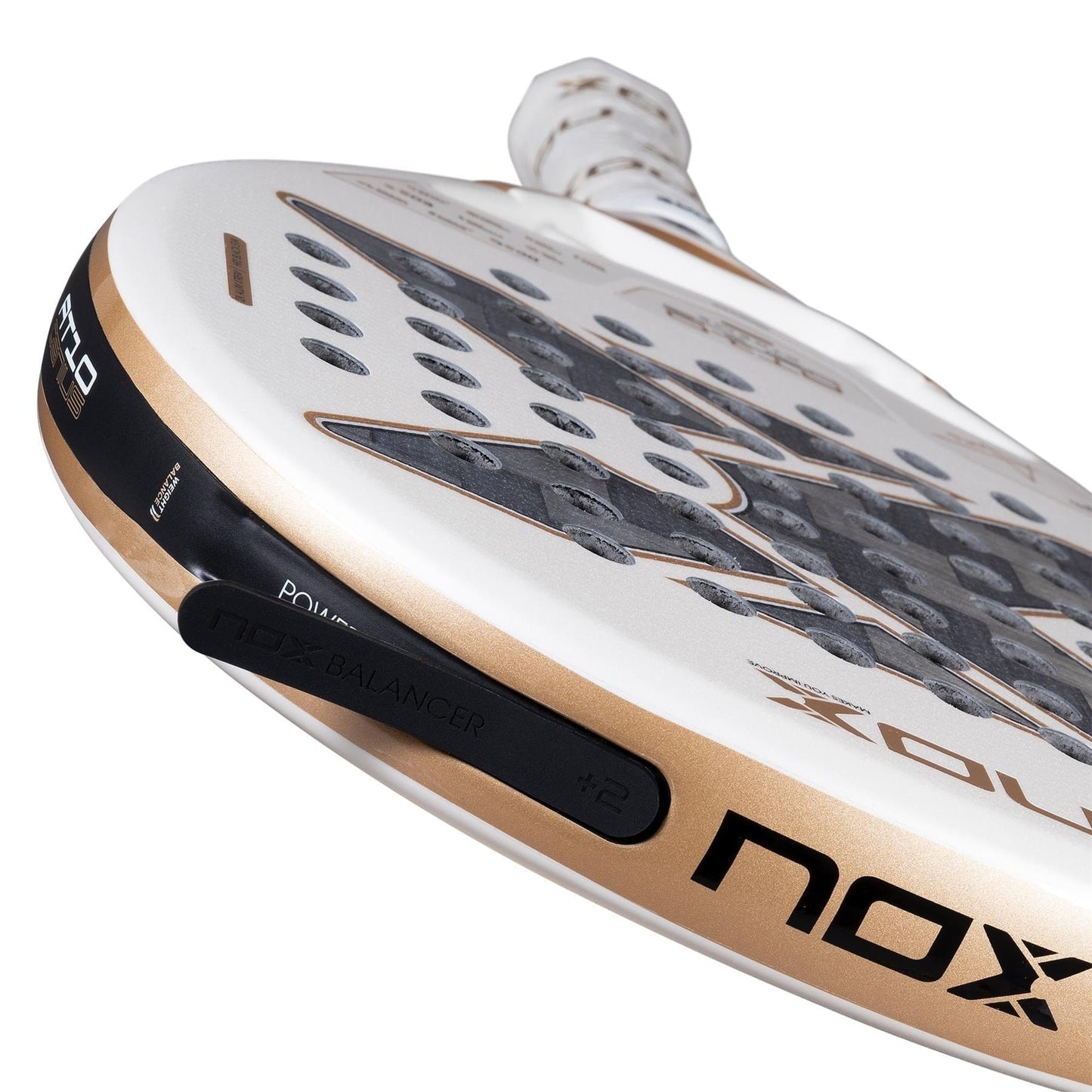Close-up of the NOX AT10 Genius 12K Alum Extrem By Agustín Tapia 2026 padel racket, with a white and gold design, black grip, and NOX Balancer weight system—a top model from NOX endorsed by Agustín Tapia.