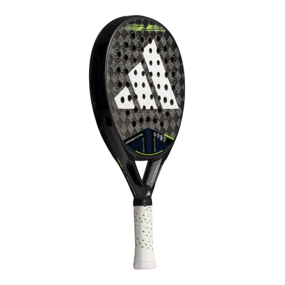 The adidas ADIDAS Cross It CTRL 3.4 Padel Racket features a black and grey Carbon 15K face, white perforated surface, green accents, and a white grip handle with black dots. The adidas logo stands out on the racket face.
