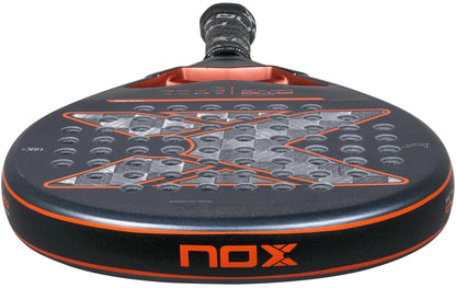 Close-up of the NOX AT10 Luxury Genius 18K Alum By Agustin Tapia 2025 Padel Racket in black and orange, featuring an 18K Alum textured surface with circular holes, a bold "X" design, and a comfortable black and grey grip.