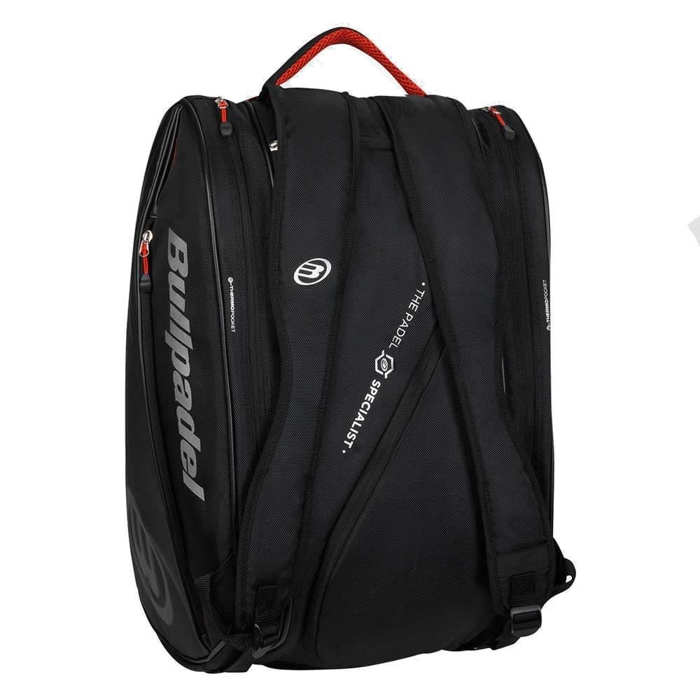 The Bullpadel BPP26020 Neuron Padel Racket Bag in black features red accents, two padded shoulder straps, a top handle, multiple zippered compartments, the Bullpadel logo on the side and strap, and thermal racket compartments for protection.