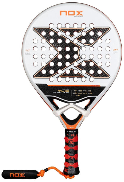 The NOX ML10 Luxury Quantum 3K By Miguel Lamperti 2025 padel racket features a white and black 3K carbon fibre face with orange accents, bold "X" design, black/red grip tape on the handle, and an attached black wrist strap.