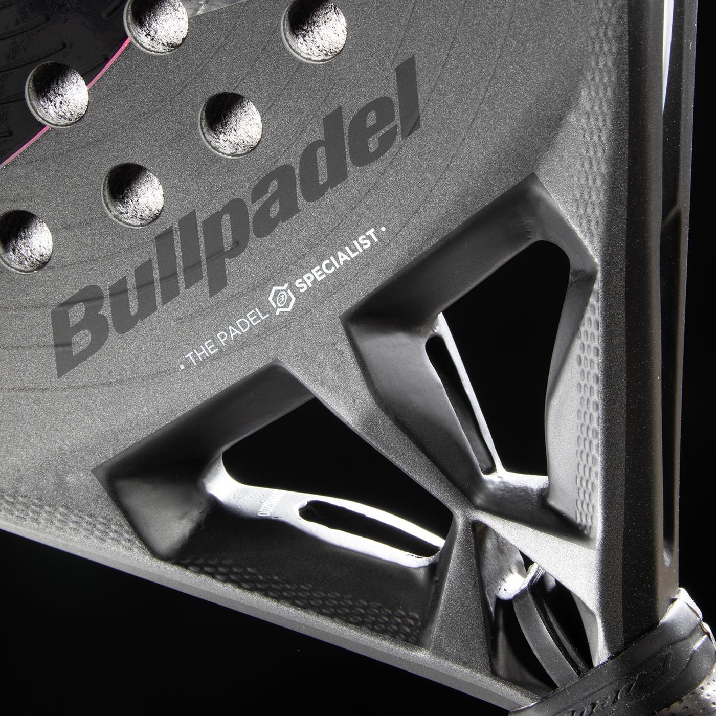 Close-up of the Bullpadel HACK 04 Hybrid 2026 Padel Racket in black, featuring Bullpadel branding, a textured surface, Total Channel technology, and a triangular open frame against a black background.