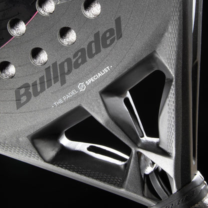 Close-up of the Bullpadel HACK 04 Hybrid 2026 Padel Racket in black, featuring Bullpadel branding, a textured surface, Total Channel technology, and a triangular open frame against a black background.