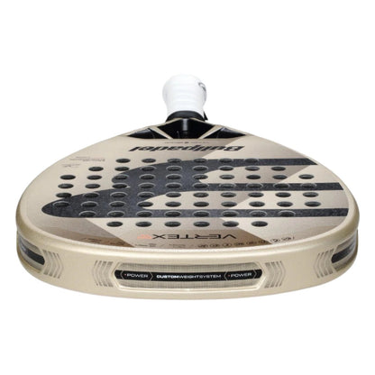 A close-up of the Bullpadel Vertex 04 W 2025 padel racket for advanced players, showing its beige body with black accents, perforated face, white grip, and "Vertex" and "Custom Weight System" near the bottom edge.