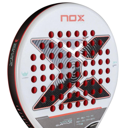 Close-up of the NOX Luxury VK10 Quantum 3K By Aranzazu Osoro 2025 padel racket in white, with red and black accents, a large black "X" Quantum 3K design at the center, and circular red holes across the face.