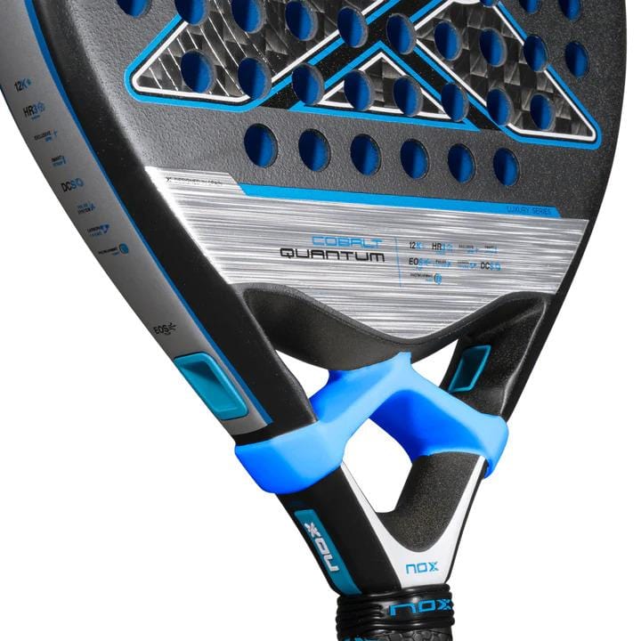 Close-up of the NOX Luxury Quantum 12K Cobalt 2025 Padel Racket, featuring a sleek black, blue, and silver design with circular holes—crafted from durable 12K carbon fibre for top performance.