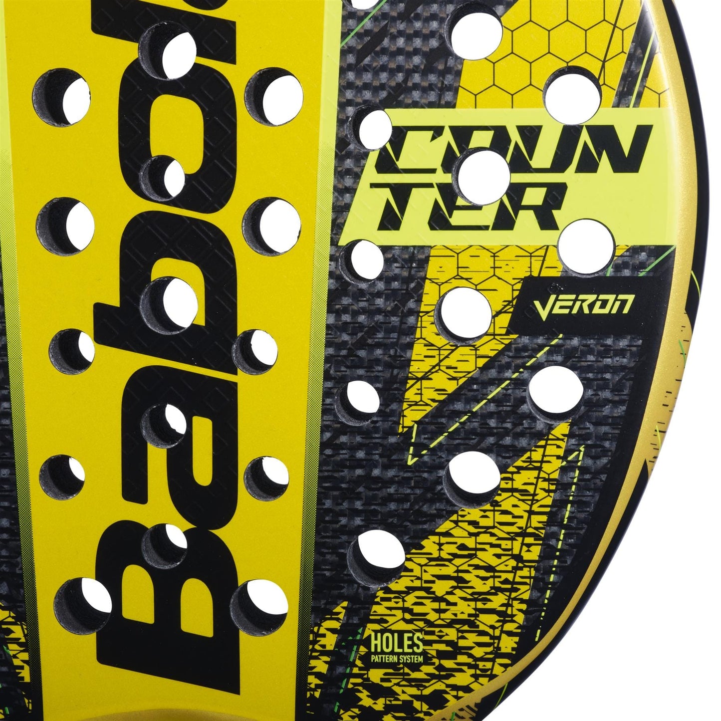 Close-up of the Babolat Counter Veron Padel Racket face in yellow and black, displaying "COUNTER," "VERON," "HOLES PATTERN SYSTEM," round holes, a honeycomb design, and advanced Carbon Flex technology.