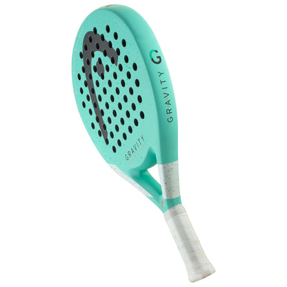 A turquoise HEAD Gravity Team Light 2024 Padel Racket—the lightest option for intermediate players—features a white grip, black HEAD logo, and round holes on the face, shown angled on a white background.