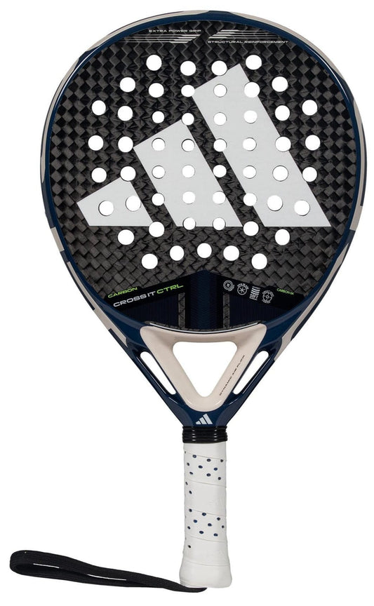 The adidas Cross It Carbon CTRL Padel Racket features a black and white design, a large adidas logo, circular holes on the carbon fibre face, plus a white handle with blue dots and a black wrist strap.