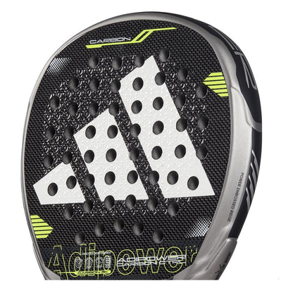 Close-up of the adidas ADIDAS Adipower Carbon CTRL 3.4 Padel Racket in black and silver, with carbon 18K construction, bold white logo, circular perforations, yellow-green accents, and "Adipower" partly visible near the bottom.