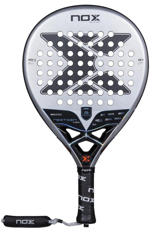 The NOX NFA Nextgen Pro Hybrid 3K Padel Racket by NOX features a silver and black design with a large "X" pattern, multiple round holes, a carbon 3K finish, black grip tape on the handle, and an attached black wrist strap.