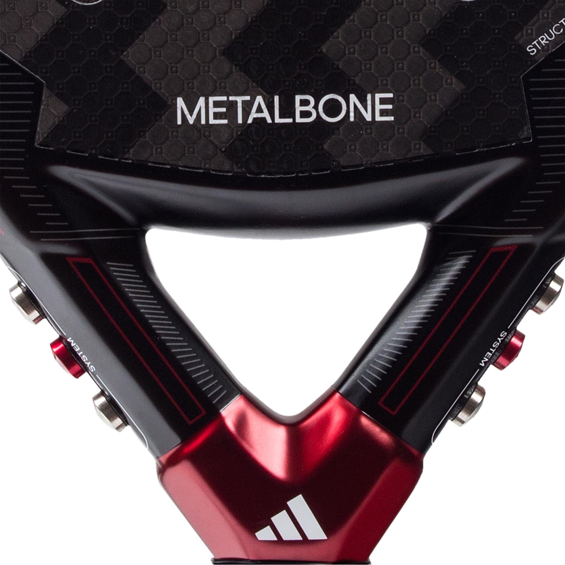 Close-up of the lower section of the adidas Metalbone 3.3 Padel Racket, featuring "METALBONE" on the face, the adidas logo near the handle, and a textured, carbon fiber-like surface.