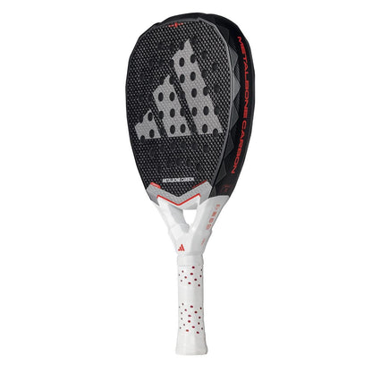 The adidas Metalbone Carbon 3.4 padel racket features a black face with a large Adidas logo, a white and red handle, and "METALBONE CARBON" on its side. Its textured, dotted design suits advanced players seeking top performance.