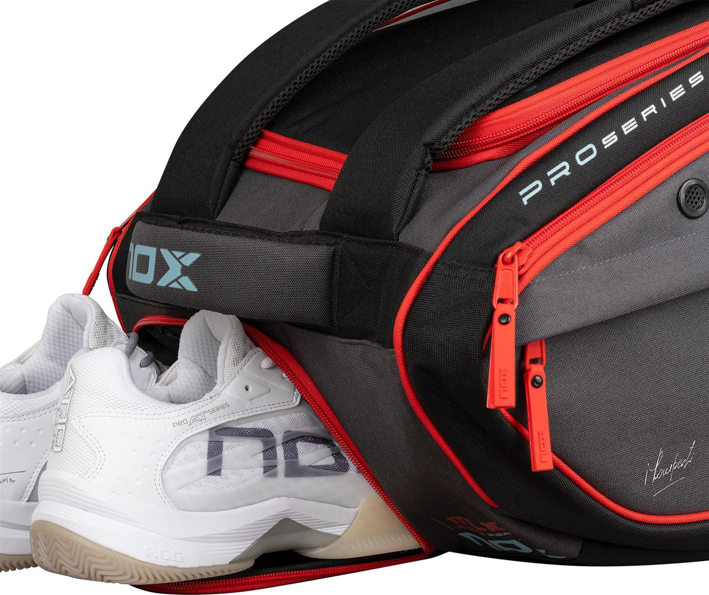 A pair of white sports shoes are partially inside the NOX ML10 Team Padel Racket Bag - Black / Clay, featuring red zippers and "PRO SERIES" and "NOX" branding clearly visible on the side.