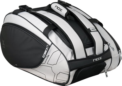 The NOX Luxury Master Series Padel Racket Bag in black and white offers multiple zippered compartments and sturdy handles, ideal for carrying your gear in style.