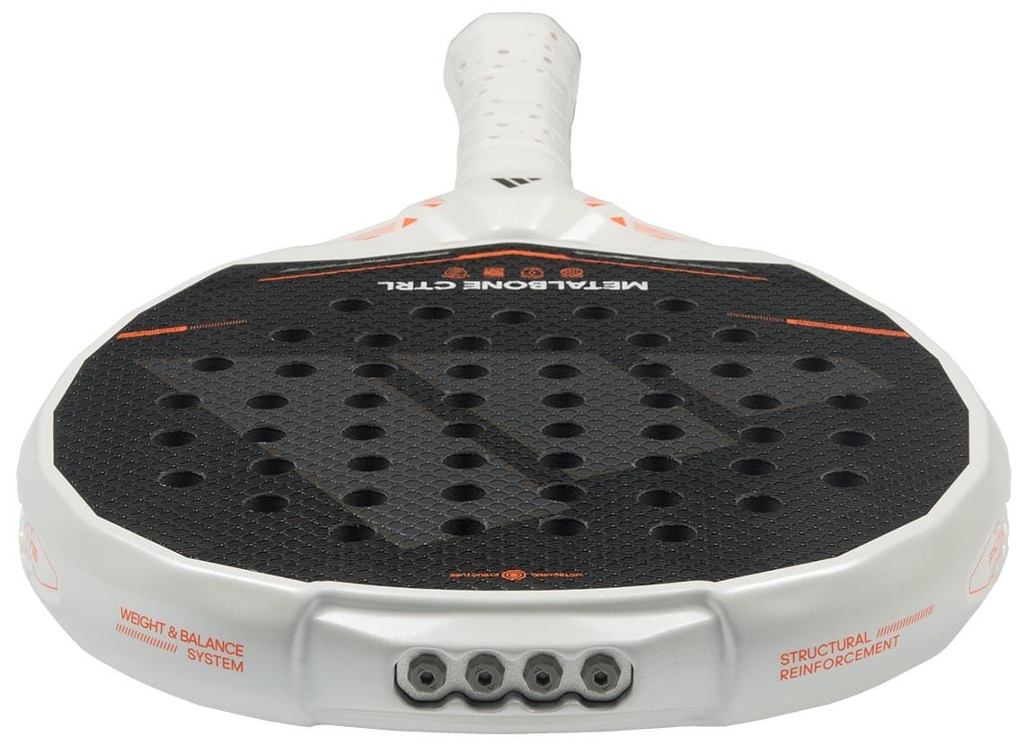 A close-up of the adidas Metalbone Ctrl 2026 padel racket shows its black face with circular holes, white frame, white grip tape on the handle, orange accents, and an adjustable weight system.