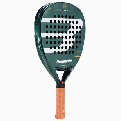 A green Bullpadel Icon 2026 Padel Racket with a tan grip, black circular holes, and white-orange branding. The model name "ICON" appears at the top, inspired by Juan Martín Díaz's legendary padel racket style.