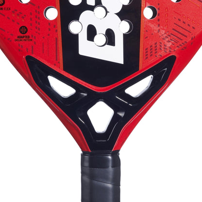 Close-up of the Babolat Alioth Pro Junior Padel Racket by Babolat, featuring a textured red and black design with triangular holes near the throat—perfect for young players looking for control.