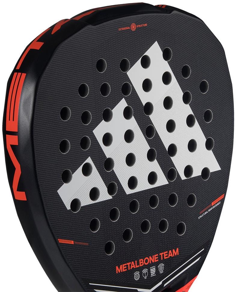 Close-up of the adidas Metalbone Team 2026 Padel Racket, showcasing a prominent white logo, Spin Blade Gritt surface, circular perforations, red details, and "METALBONE TEAM" at the base.