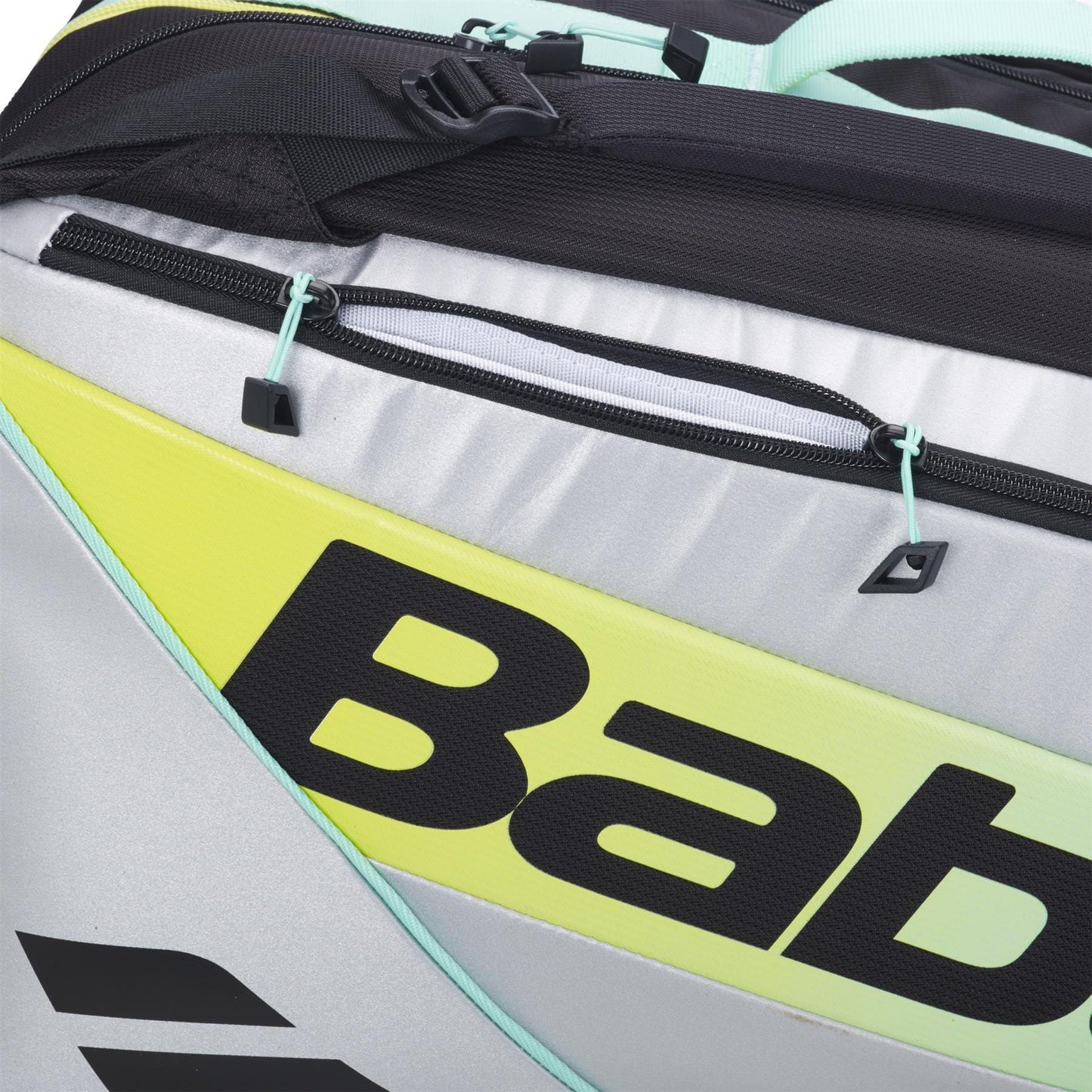 Close-up of the Babolat RH Pro Padel Racket Bag in Black/Multi with gray, yellow, and mint green accents, bold partially visible “Bab” branding, black zipper and straps, and a spacious design for padel gear.