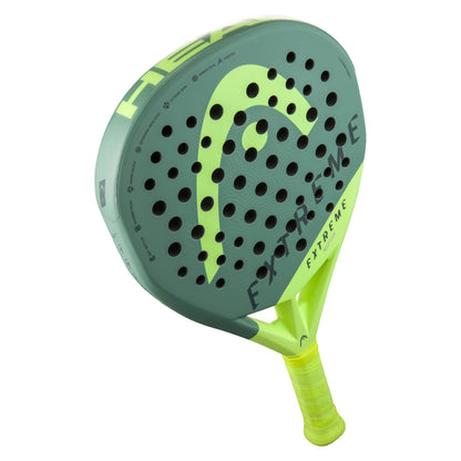 The HEAD Extreme Elite 2023 Padel Racket features a diamond shape, green and yellow design, perforated face, and a bright yellow grip for comfort.