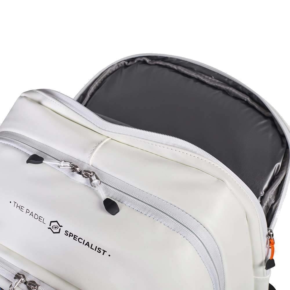 A close-up of the Bullpadel BPM26009 Vertex W Padel Backpack in white with partially opened zippers shows its grey interior. The front pocket displays “The Padel Specialist” logo, making it perfect for carrying your padel racket.