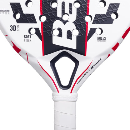 Close-up of the Babolat Technical Vertuo Juan Lebrón Padel Racket, showing its textured surface, perforations, red accents, branded logos, and a wrapped white grip handle.