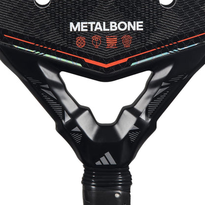 Close-up of the upper handle and lower face of the adidas Metalbone by Ale Galán 2026 Padel Racket, showing "METALBONE" branding, feature icons above the handle, and highlighting its weight and balance system.