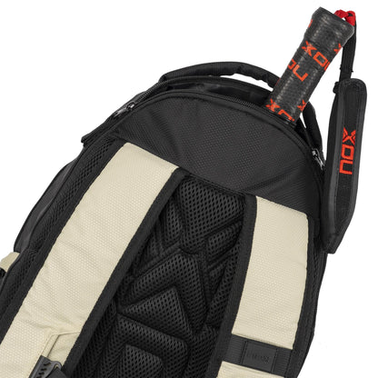 A close-up of the NOX Street Series Padel Racket Bag in black and grey, with padded straps and a tennis racket handle emerging from the top compartment.