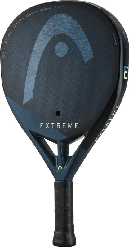 The black and blue HEAD Extreme One X 2025 Padel Racket features a single center hole, a 12K carbon fibre textured surface, a black grip, and displays the HEAD logo with "EXTREME" clearly visible on the face.