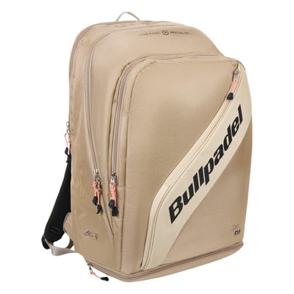 The Bullpadel Vertex 25 Padel Backpack in stone features multiple compartments, black zippers, and a reinforced thermo-lined section. The brand name is prominently displayed diagonally across the front in black letters, making it perfect for stylishly carrying your Vertex Padel Racket and essentials.
