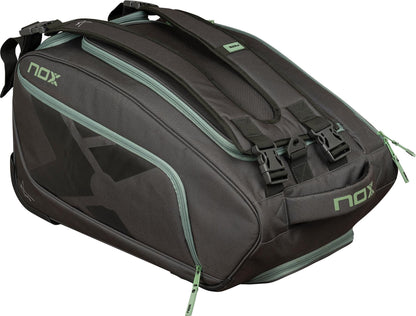 The NOX AT10 Competition Trolley Padel Racket Bag in black/green features wheels, ample compartments, handles, and bold NOX branding—making it a spacious and practical choice for padel players.
