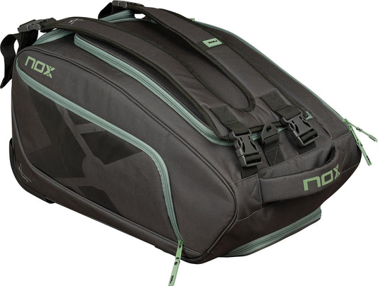The NOX AT10 Competition Trolley Padel Racket Bag in black/green features wheels, ample compartments, handles, and bold NOX branding—making it a spacious and practical choice for padel players.