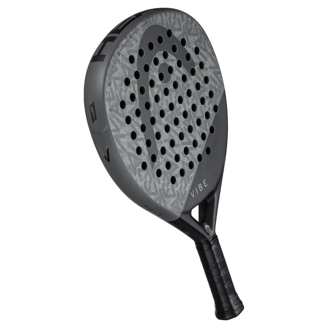 The HEAD Vibe 2025 Grey / Black Padel Racket by HEAD features a teardrop shape, patterned face with multiple perforations, and "VIBE" near the handle, displayed against a white background.
