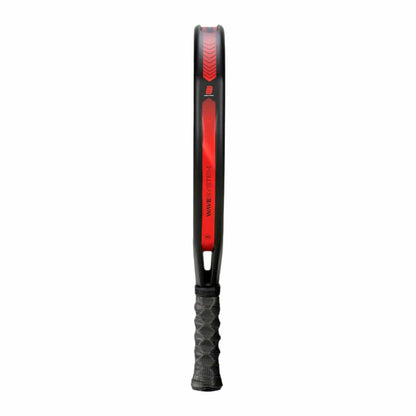 The Bullpadel Xplo 2025 Padel Racket by Bullpadel features black and red accents, a slim frame, and a textured grip handle, shown side-on against a white background.