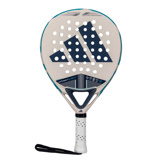 The adidas Cross It Team Light 3.4 Padel Racket is beige with a large navy logo, circular holes on the surface, and a white handle with a black strap—ideal as a lightweight option for advanced padel players.