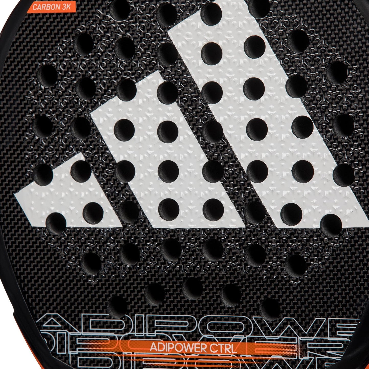 Close-up of the adidas ADIDAS Adipower CTRL 3.3 Padel Racket featuring a black textured surface, large white geometric logo, circular holes, and "ADIPOWER CTRL" in orange—an elite control padel racket by adidas.