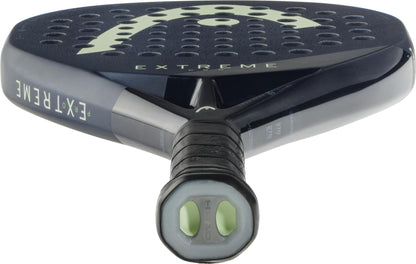 Close-up of the HEAD Extreme Pro 2025 Padel Racket in black, showing perforated face, "EXTREME" near the throat, a black grip on the handle, and visible HEAD logo markings.