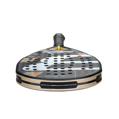A close-up of the Bullpadel Neuron 02 2026 Padel Racket highlights its perforated face, textured surface, and sleek black, gray, and gold design. The handle features a black grip tape for optimal control.