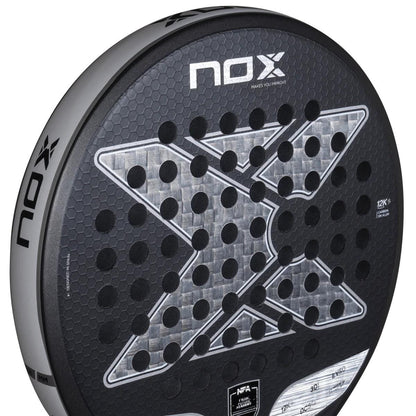 Close-up of the NOX NFA Future Control 12K Alum Padel Racket, featuring a large silver "X," honeycomb texture, black circular holes, and the NOX brand name on the top and side.