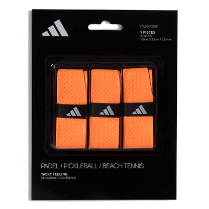 The adidas Padel Overgrips (3 Pack) in orange offer comfort and performance with micro-perforations. Suitable for padel, pickleball, or beach tennis; features adidas branding on sleek black-and-white packaging.