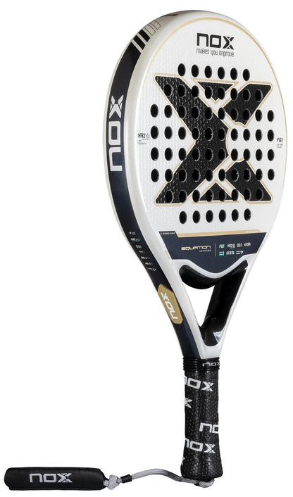 The NOX Equation Advance Series Padel Racket in black and white features a perforated surface, black grip, wrist strap, and brand logo on the face and handle—ideal for intermediate players.