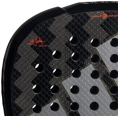 Close-up of the adidas Metalbone by Ale Galán 2026 Padel Racket face, featuring circular holes, a geometric texture, and the red "Ale Galán" signature highlighting the Spin Blade Decal for added spin.