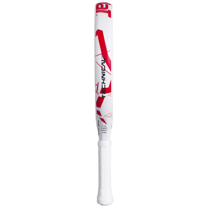 A white Babolat Technical Vertuo Juan Lebrón padel racket stands upright on a plain white background, featuring red geometric designs, modern styling, and a sleek white grip.