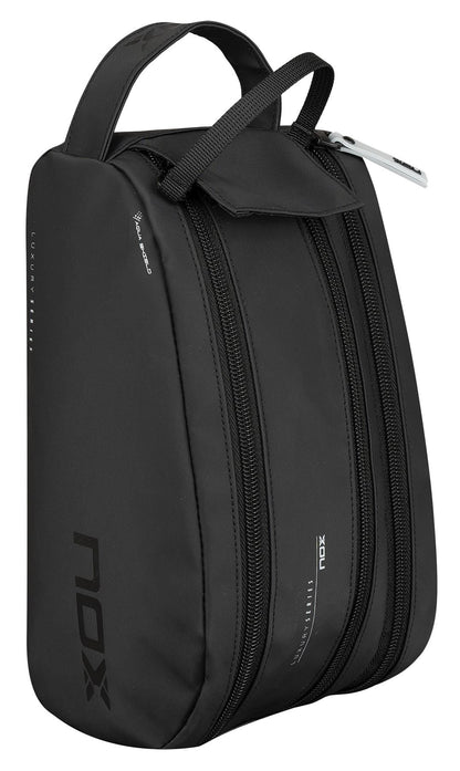 The NOX Luxury Travel Kit Bag - Black / Grey features a top handle and two zippered compartments, making it an ideal organiser for keeping essentials neat while traveling. Shown upright on a white background.