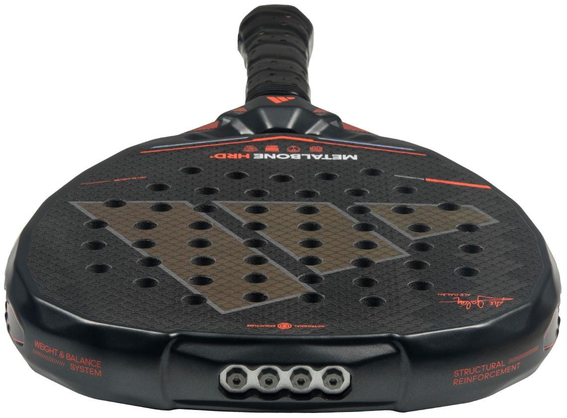Close-up of the adidas Metalbone HRD+ by Ale Galán 2026 Padel Racket, a power racket featuring a textured black face with red accents, multiple holes, visible grip and handle end, plus adidas branding details.