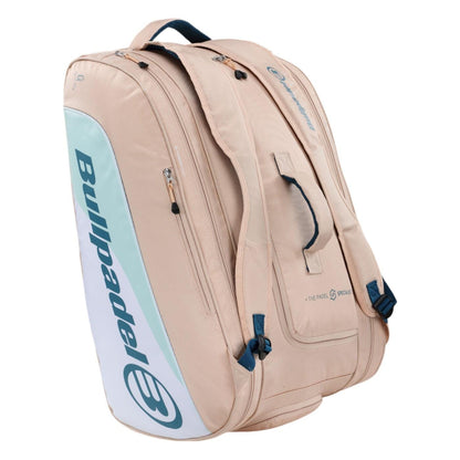 A pink Bullpadel Elite 25 padel racket bag featuring thermo-lined compartments and adjustable straps. This sleek bag, displaying the brand's logo, is designed for gear transport with a style inspired by Gemma Triay.