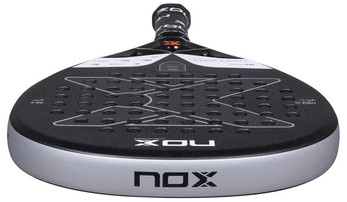 Close-up of the NOX NFA Nextgen Pro Attack 3K Padel Racket by NOX, featuring its perforated surface and visible brand logos on both the base and top of the handle.