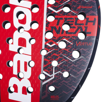 Close-up of the Babolat Technical Vertuo 2.5 padel racket in red and black, featuring hexagonal patterns, circular holes, and "Technical Vertuo" and "Holes Pattern System"—ideal for technical players seeking precision.