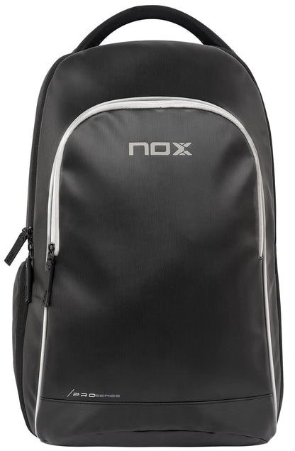 The NOX Pro Series Padel Backpack - Black features white zippers and accents, the NOX logo and "Pro Series" on the front, a spacious front zip pocket, large storage capacity, and a convenient top handle.